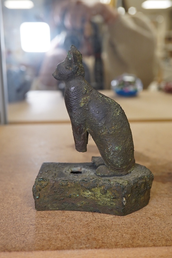 An Ancient bronze Egyptian cat, on separate base, 11.5cm in height. Condition - antique condition